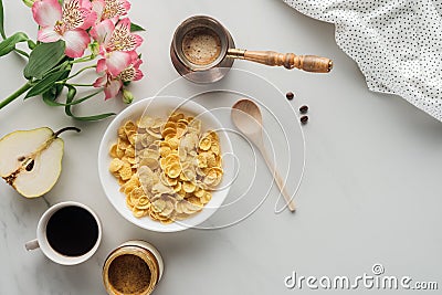 top view of bowl of cereal with coffee and flowers bouquet Stock Photo