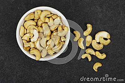 top view of bowl of Tasty cashew nuts on grunge background Stock Photo