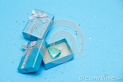 Top view of the box tied with silk ribbon on tiffany blue color pastel background Stock Photo