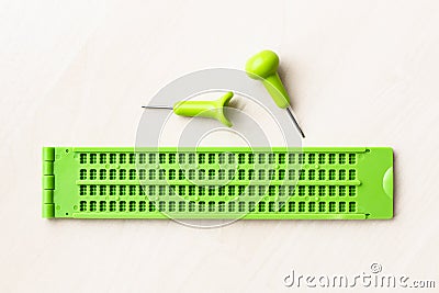 Top view of braille writing slate and stylus Stock Photo