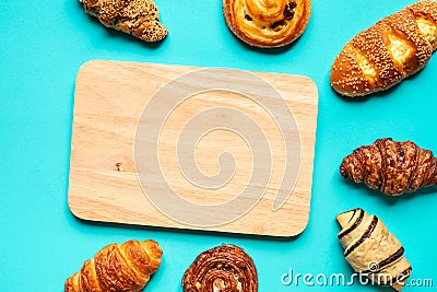 Top view of bread and bakery set with chopping board on blue color background.Food and healthy concepts Stock Photo