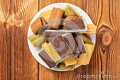 Broken multicolor sandwich cookies on a wood table Stock Photo