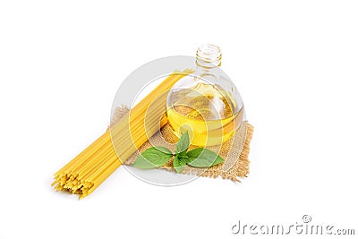 Top view of a bunch of bucatini or perciatelli - pasta, spaghetti with fresh green basil and vegetable oil placed on sackcloth. Stock Photo