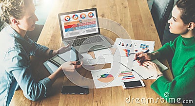 Top view.Business meeting.Two young business women sitting in meeting room at table and discussing. Stock Photo