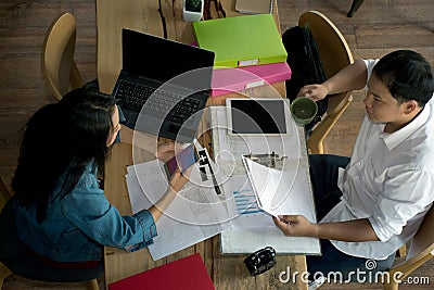 Top view of Businessmen and Businesswomen working with reports and laptop Stock Photo