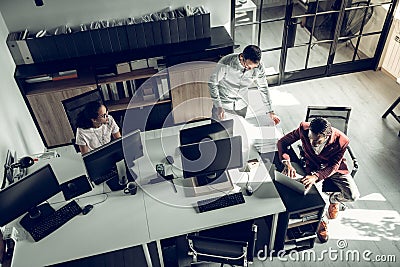 Top view of businessmen working in the team in spacious office Stock Photo