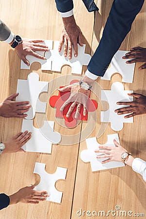 top view of businesspeople assembling puzzle Stock Photo