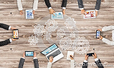 Top view of businesspeople sitting at table and using gadgets Stock Photo