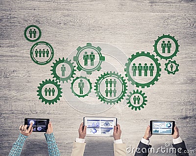 Top view of businesspeople sitting at table and using gadgets Stock Photo