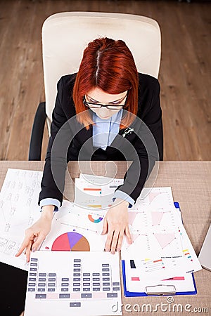 Top view of businesswoman looking at diagrams Stock Photo