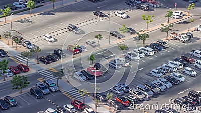 Top view busy parking lot with many cars moving in and out timelapse. Stock Photo