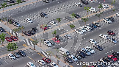 Top view busy parking lot with many cars moving in and out timelapse. Stock Photo