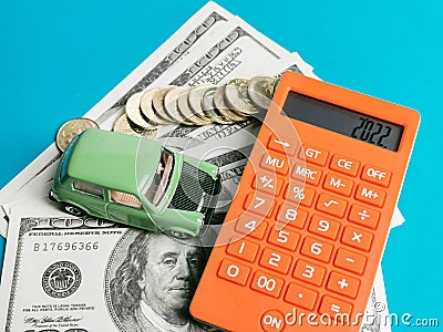 Top view calculator with toy car, coins and fake money. Stock Photo