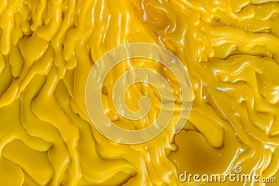 Top view of the candle melts droplets dissolve in yellow from lighted candlestick Stock Photo