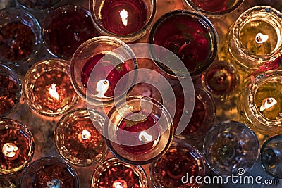 Top view of candles in round small glasses from a Buddhist temple in Vietnam Stock Photo