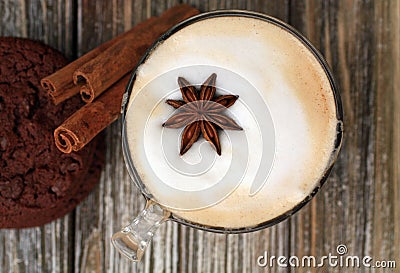 Top view of Cappuccino with star cinnamon sticks. Chocolate chip cookie. Stock Photo