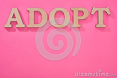 Top view of cardboard word adopt on pink background with copy space. Stock Photo