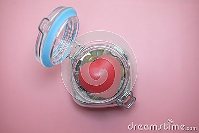 Top view of Charity money jar on pink background Stock Photo