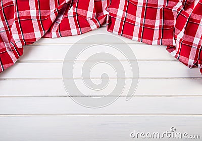 Top view of checkered kitchen towels on wooden table Stock Photo