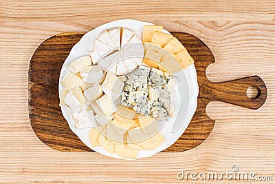 Variety of cheese kinds on wooden board Stock Photo