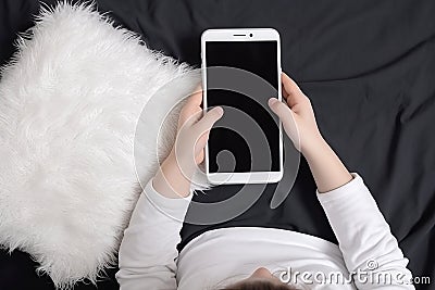 Top view child sitting and holding blank screen mock-up mobile phone AI generated Stock Photo