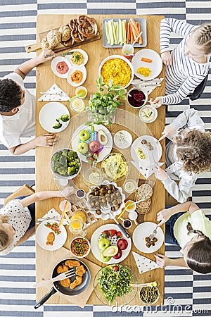 Top view of children eating healthy homemade meal. Wooden table Stock Photo