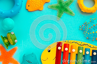 Top view on children`s educational and music games, frame from multicolored kids toys on light blue paper background. Circles, Stock Photo