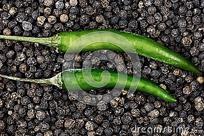 Top view of chili pepper green pod closeup black peppercorn. pair parallel pods Stock Photo