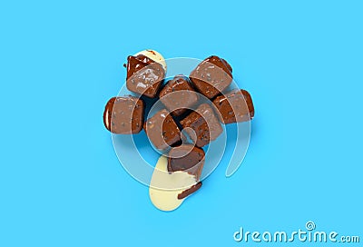 chocolate blocks with vanilla flavor ice cream inside starts melting on blue background Stock Photo