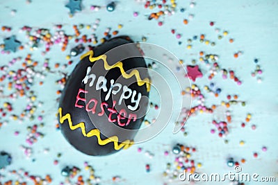 Chocolate egg written with happy Easter text Stock Photo