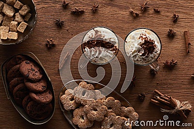 Top view of Christmas cacao near cookies, anise, cinnamon and brown sugar on wooden table. Stock Photo