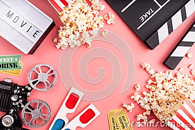 Top view of clapper board, movies tickets, popcorn and lightbox with word Movie on pink background with copy space Stock Photo