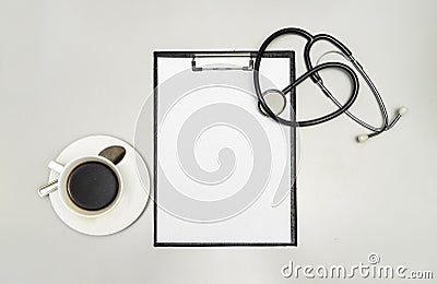Top view clipboard, stethoscope and cup of coffee on white background Stock Photo