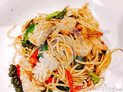 Closeup fusion seafood stir fried spicy spaghetti Stock Photo
