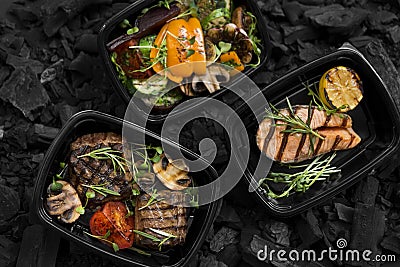 Top view of coal cooked healthy food in take away boxes Stock Photo