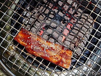 Top view of a cocked piece of meat on round metal grill on Japanese Yakiniku style Stock Photo