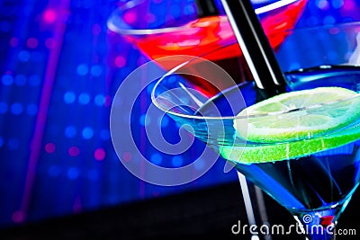 Top of view of cocktail with blue light disco background with space for text Stock Photo