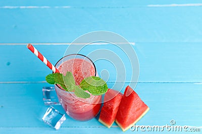 Top view cold watermelon juice in the glass on old blue wooden table Stock Photo