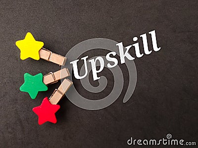 Top view colored wooden clips with text Upskill Stock Photo