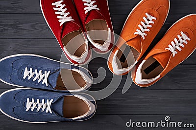 Colorful casual unisex suede sneakers on grey wooden planks Stock Photo