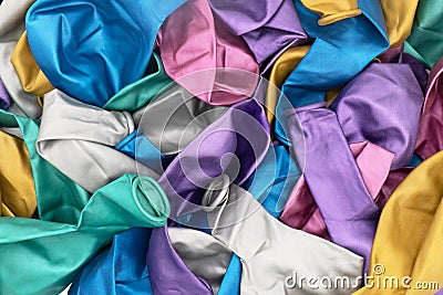 Top view of colorful deflated balloons texture background. Pile of multiple colorful unblown balloons pattern. Heap of colorful Stock Photo