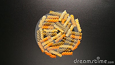 TOP VIEW: Colorful fusilli pastas on a black table Stock Photo