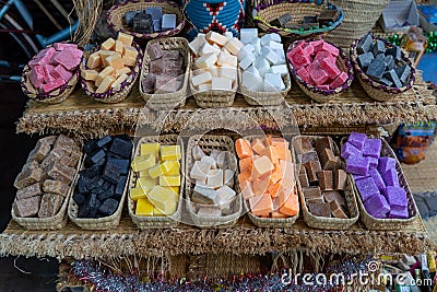 Top view of colorful soaps in thatch baskets on a selling stand Stock Photo