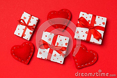 Top view of colorful valentine background made of gift boxes and red textile hearts. Valentine`s Day concept Stock Photo