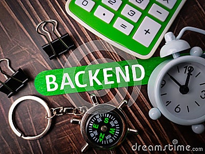 Top view compass,paper clips,clock and calculator with text BACKEND Stock Photo