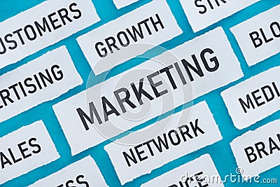 Top view of components of marketing on pieces of paper isolated on blue. Stock Photo