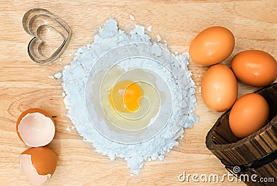 Top view composition flour with egg and ingredients for homemade bakery on wooden background Stock Photo