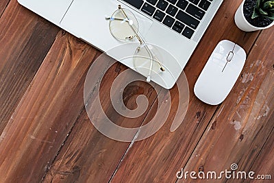 Top view of Computer laptop plant and glasses on wooden desk for work from home Editorial Stock Photo