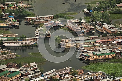 Top view of congested houseboats, shikara, boats, and houses in blue waters of Dal Lake. Jammu and Kashmir, India Editorial Stock Photo