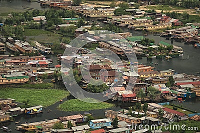 Top view of congested houseboats, shikara, boats, and houses in blue waters of Dal Lake. Jammu and Kashmir, India Editorial Stock Photo